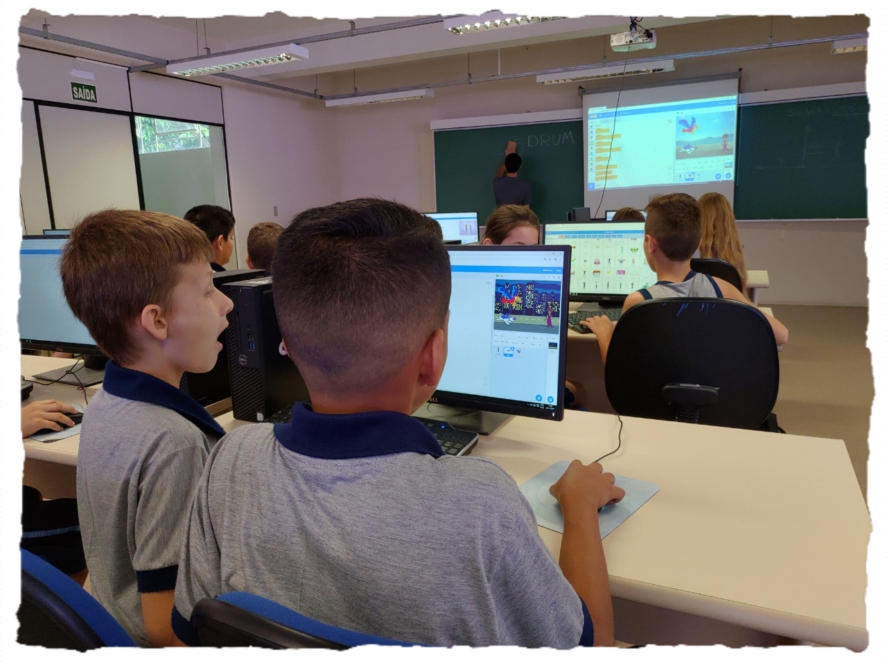 criança apontando para a tela de um computador